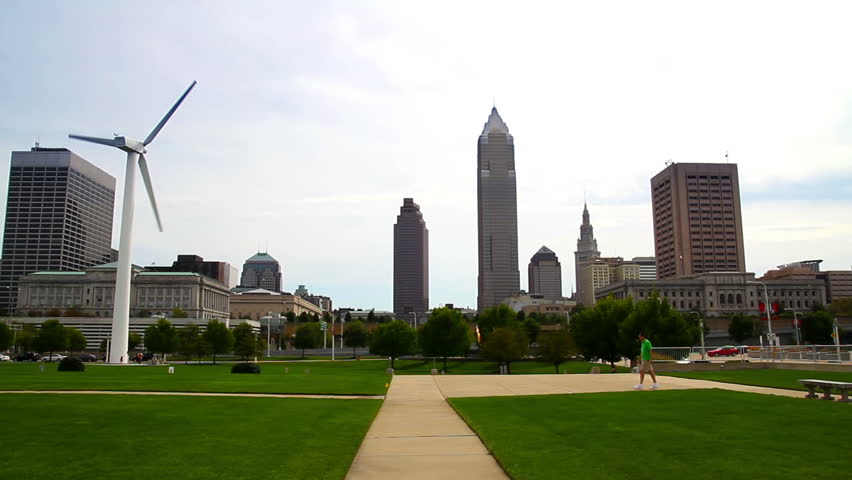 The skyline of Cleveland, Ohio as seen from the shore of Lake Erie.  The windmill at the Great Lakes Science Center is seen in the foreground.