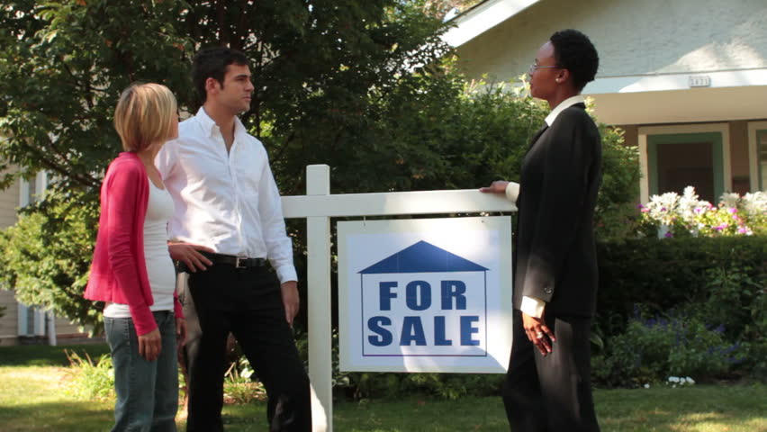 Real estate agent showing couple a house