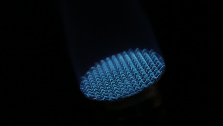 A flame comes in and lights a bunsen burner in a lab,.