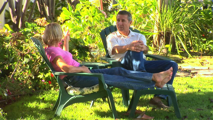 Mature couple relaxing outside making a toast