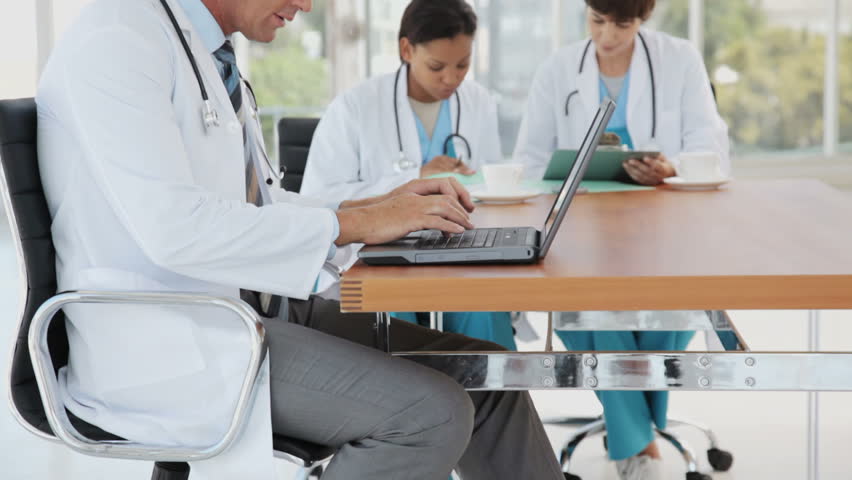 Male Doctor Multitasking on a Break