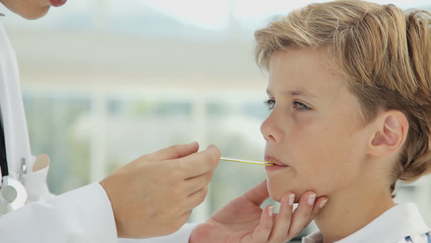 Doctor Checking the Temperature of a Boy