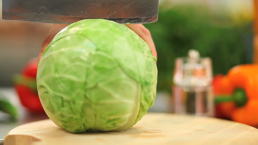 The cook cuts cabbage