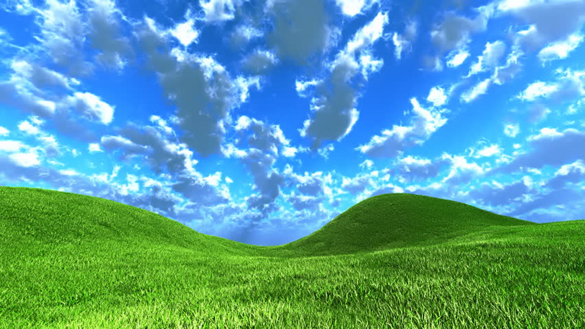 Clouds moving in clear blue sky above green grassy hills