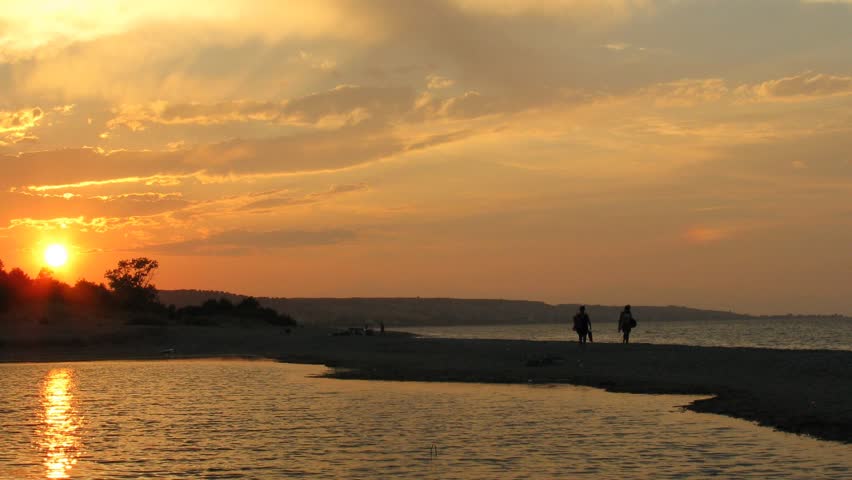 Sunset: shallow on the sea. Sun leaves for horizon. Time lapse.