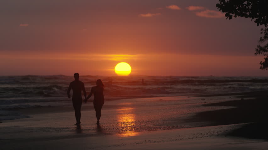 Contented Senior Couple Enjoying A Romantic Sunset Evening Together On