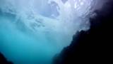 POV perspective as a swimmer surfaces in the ocean near a rocky shoreline.  Filmed in 720p HD at 60 FPS.