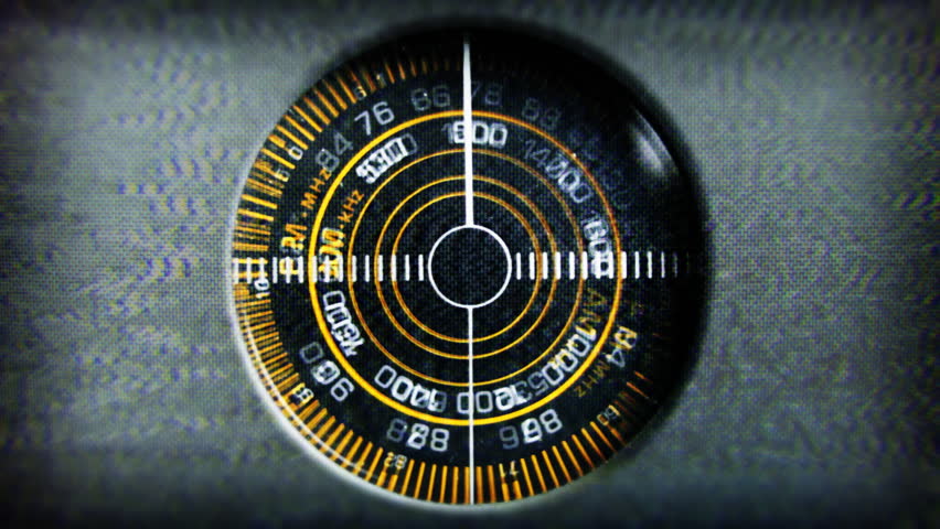 Close-up of the circular radio dial of an old retro radio
