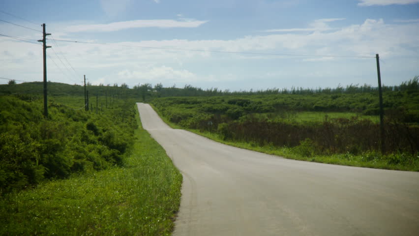 A van drives down an empty road in the countryside