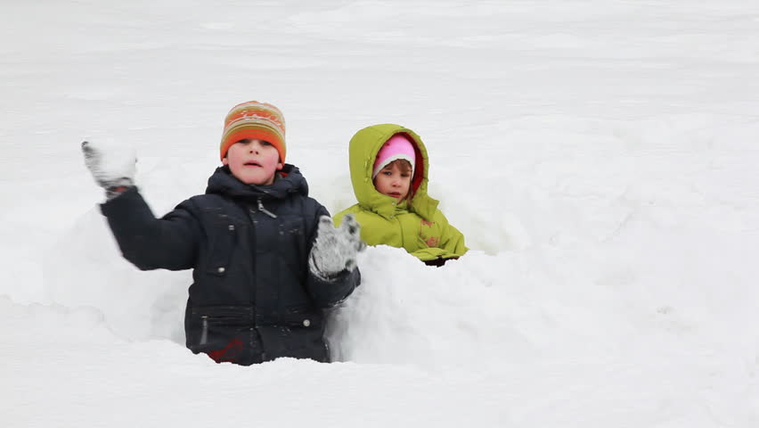 little girl and boy are buried in the snow 