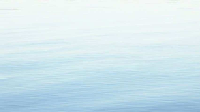 Serene ripples of water hypnotize the viewer in this footage of pure lake water.