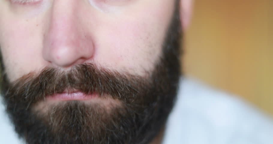Bearded Man Standing In Front Of Mirror And Looking At His Thinning