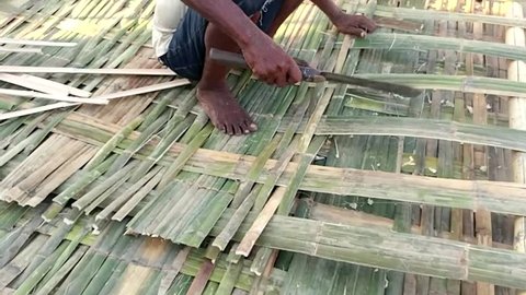 Tamatave Toamasina Ii Madagascar 02 03 2018 An Artisan Weaving A Bamboo Panel Used For Walls And Ceilings In Madagascar