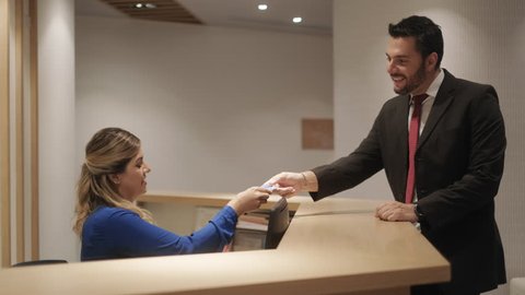 Businessman Smiling At Hotel Reception Stockvideos Filmmaterial