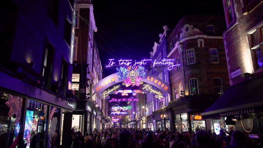 Christmas Lights Neon Street Illumination Stock Footage Video 100 Christmas Lights Neon Street Illumination Crowd Of People Walking Through Carnaby In The Soho District Downtown London City At Night