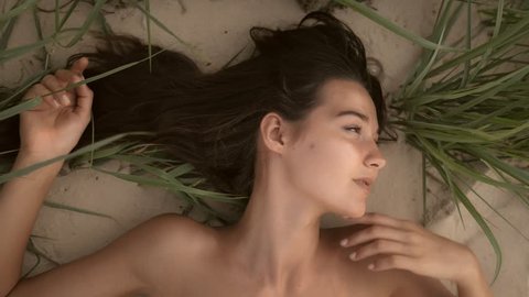 480px x 270px - Nude beautiful woman on the nudist beach. lady with nude perfect body  laying on sand. sensual mixed race caucasian asian girl posing on travel  vacation holidays naked outdoors. close-up portrait of