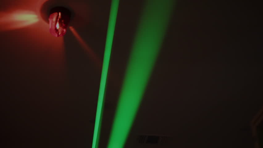 Green Lasers And Flashing Red Alarm Light