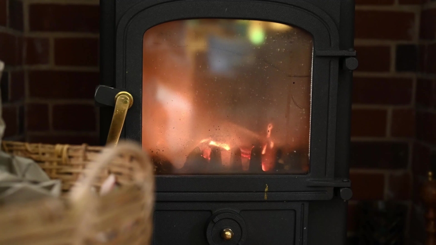 4k00 22logs Burning In A Closed Fireplace With Basket On Front Giving