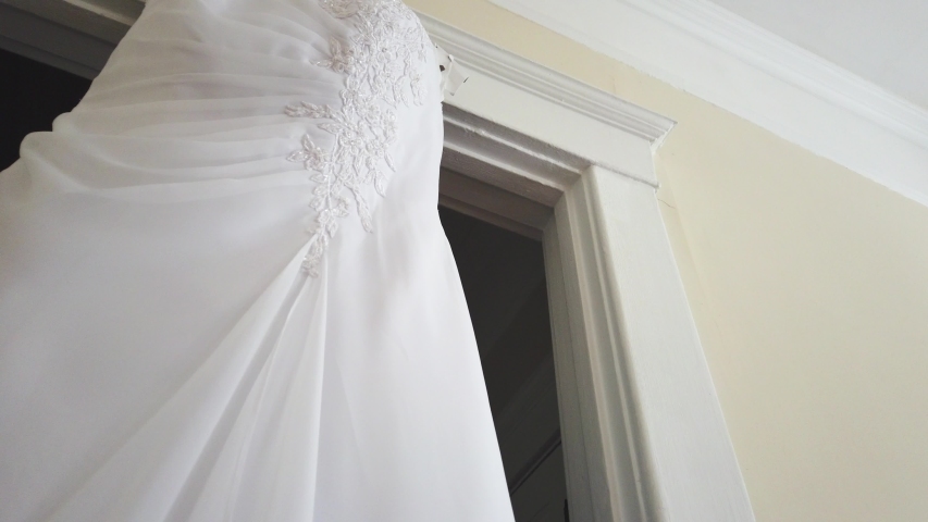 4k00 05slow Motion Reveal Of Elegant Wedding Dress Hanging In
