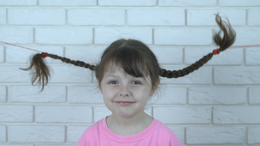 Portrait Of A Beautiful Little Girl With Pigtails Dancing Hair
