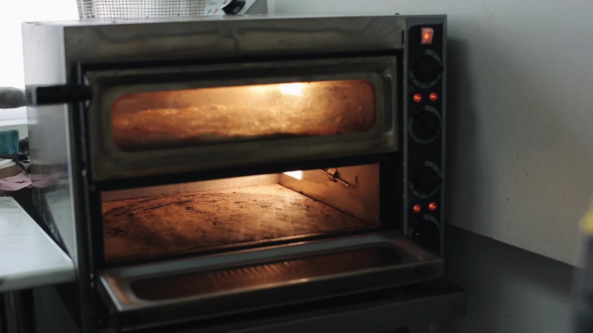 man-putting-pizza-in-the-oven-image-free-stock-photo-public-domain
