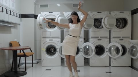 Woman Dancing Viral Dance And Have Fun In The Laundry Room Happy Business Woman Enjoying Dance Having Fun Together Party Joyful Female In Formal Dress Dancing Cheerful In Laundry Room