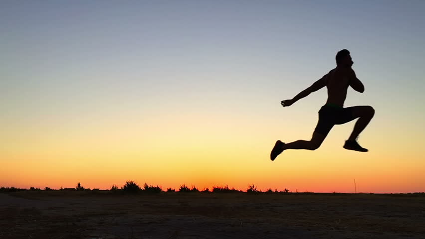 A Man Jumps Into The Sky At Sunset. Slow Motion. Beautiful Action At ...