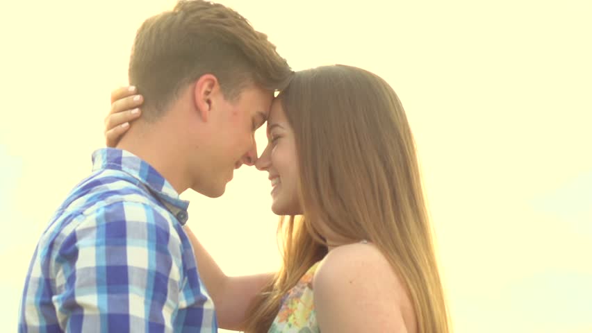 Beautiful Young Couple In Love Embrace And Kiss In A Field ...