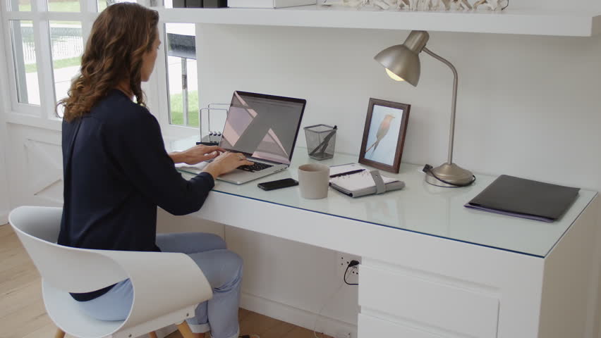 successful woman working in modern home office with laptop successful woman working in modern home office with laptop