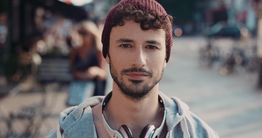 Slow Motion Portrait of happy cute caucasian man smiling in city real people series
