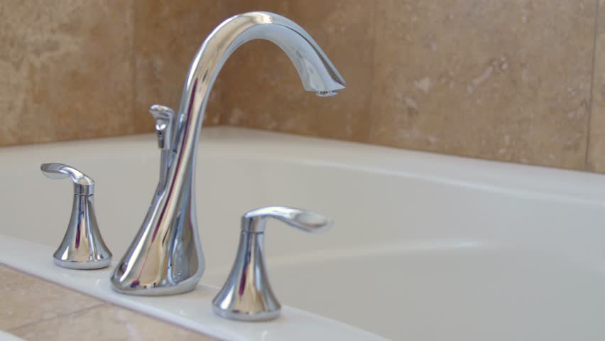Woman Turning Off Hot Water Bathtub Faucet In The Bathroom Stock A Man Turns The Faucet Handle To Turn On Hot Water And Fill Up