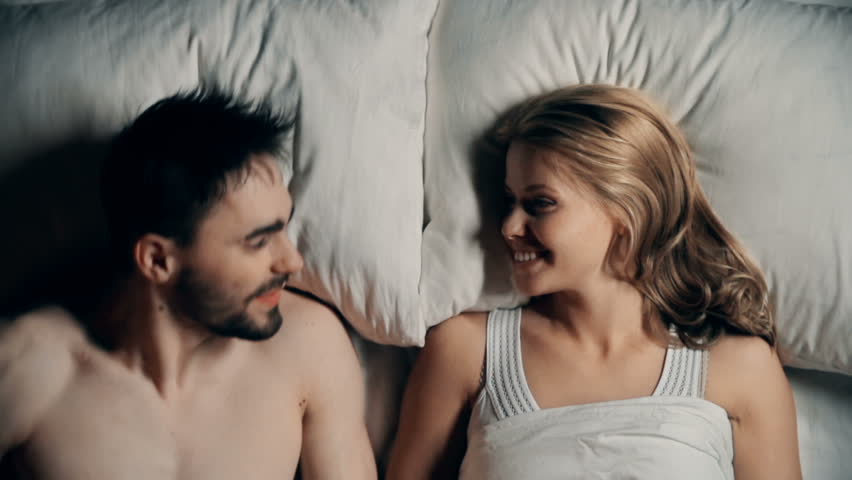 Directly Above View Of Passionate Couple Enjoying Sensual Kiss In Bed Directly Above View Of Passionate Couple Enjoying Sensual Kiss In Bed