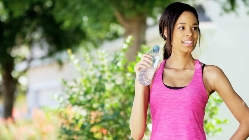 Portrait Of Young African American Girl Drinking Water And Warming Up ...