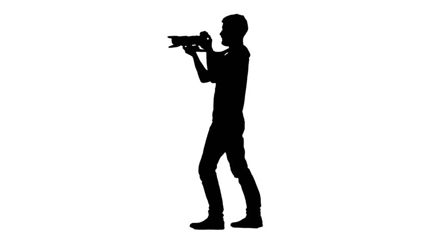 Silhouette Of Cameraman Walking With Camera And Shooting A Film ...