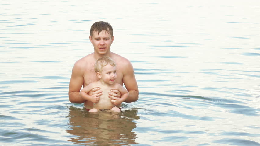 Handsome Father Holding His Naked Son On Hands Before 