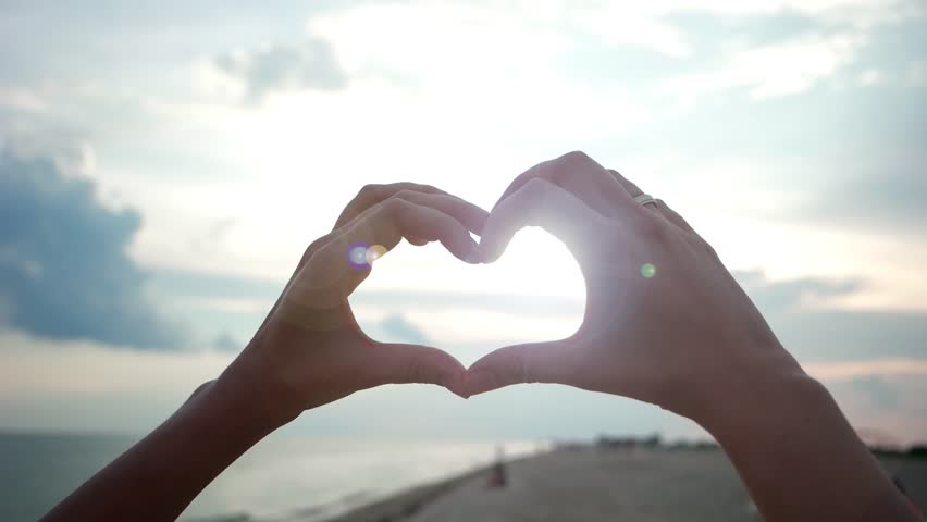 Beauty Girl Making Heart With Her Hands Over Sea Background. Happy ...