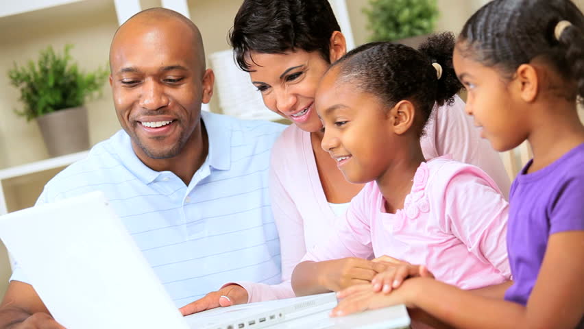 Parents are. Young Ethnik people watching wphone
