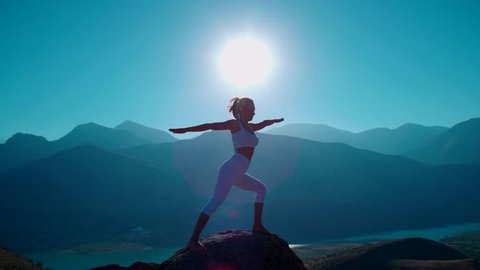 4K yoga in the mountains,the sunrise, beautiful girl in white clothes doing yoga, slow motion