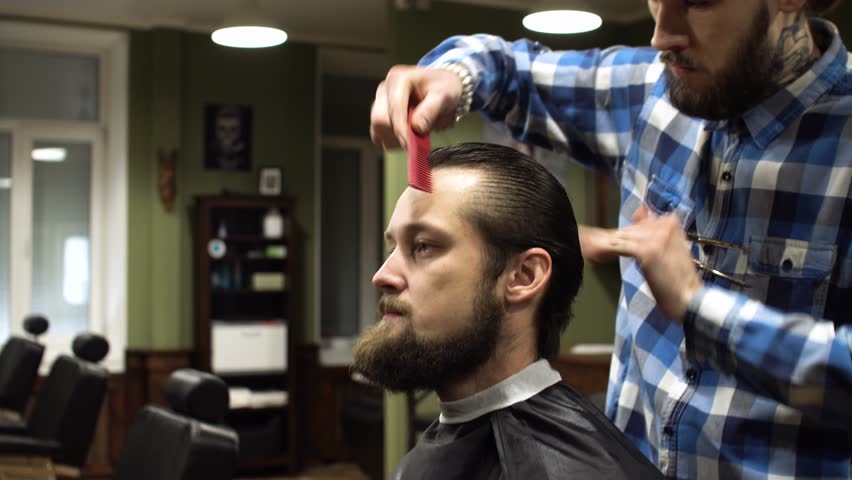4k00 12long Hair Barber Is Doing A Haircut To Young Bearded Man In