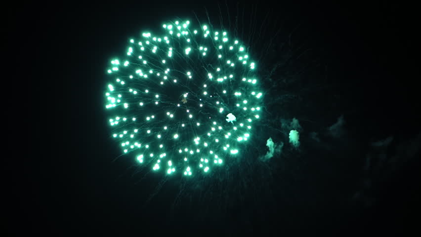 Colorful fireworks in the night sky. Red, blue and green flashes. Clouds of smoke. (av13262c)