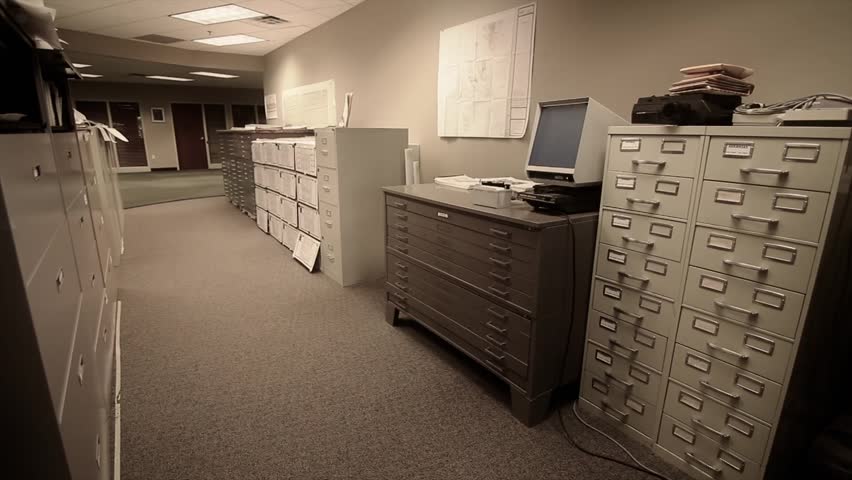 Hd00 23a Man Searches Through Large Filing Cabinets At His Business A Man Searches Through Large Filing Cabinets At His Business