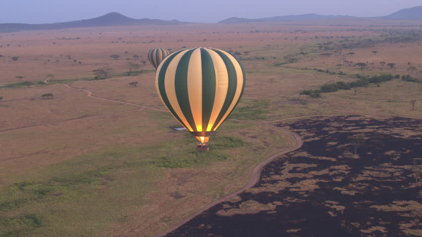 AERIAL: Safari Hot Air Balloon Flying Above Endless Savannah Plains