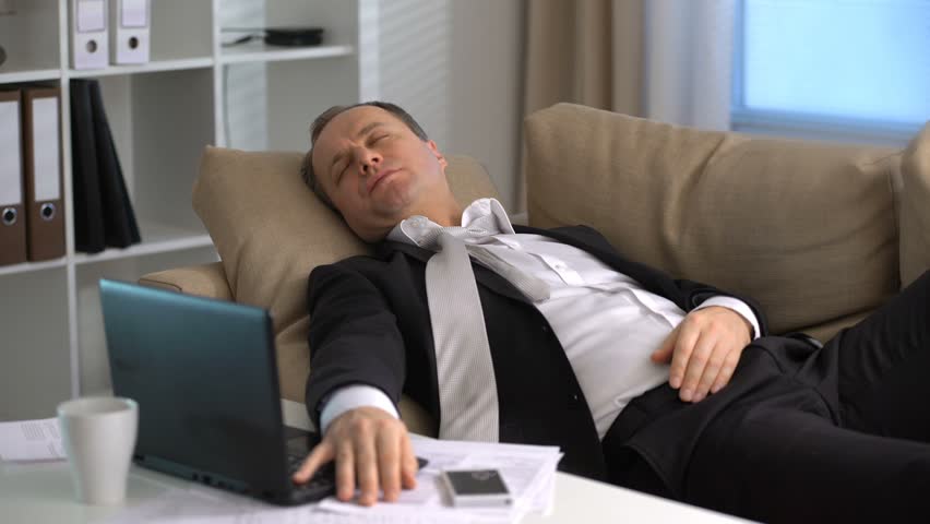 Businessman Sleeping On Couch With His Laptop In The Office Stock ...
