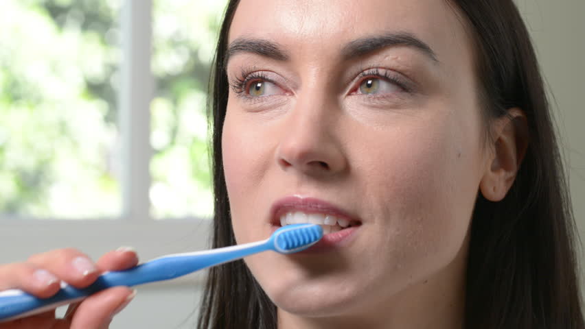 A Girl Over The Shower Brushing Teeth With A Toothbrush And Toothpaste ...