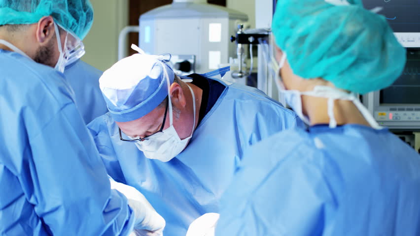 Surgical Healthcare Surgeon With Training Team In Scrubs Working In 