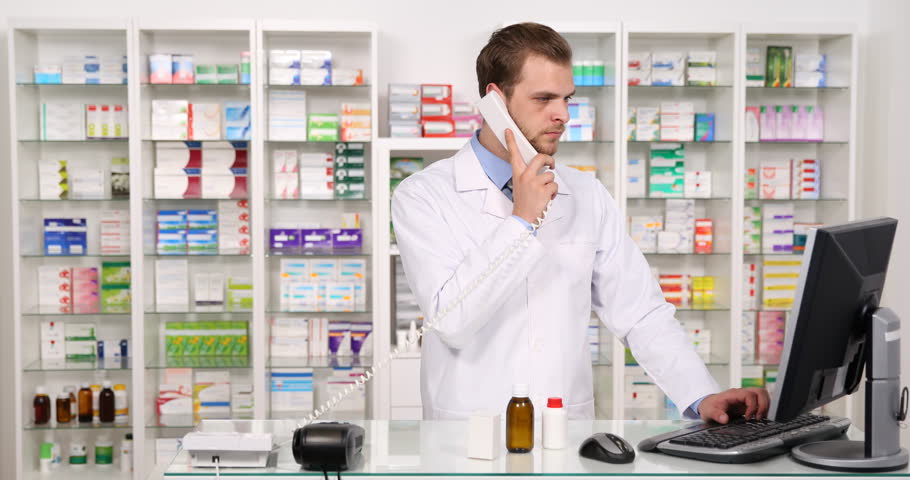 Pharmacist Man Talking Landline Phone With Customer About Medicine Pill ...