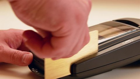 Credit card swipe through terminal machine and entering the pin code On white table, 4k video