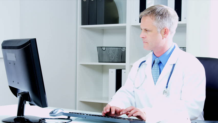 male and female caucasian medical consultants looking computer monitor in hospital office shot on red epic - Epic Consultant male and female caucasian medical consultants looking computer monitor in hospital office shot on red epic - Epic Consultant