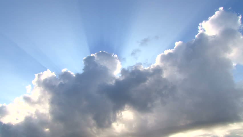 Beautiful cloudscape with large, building clouds and sunrise breaking through