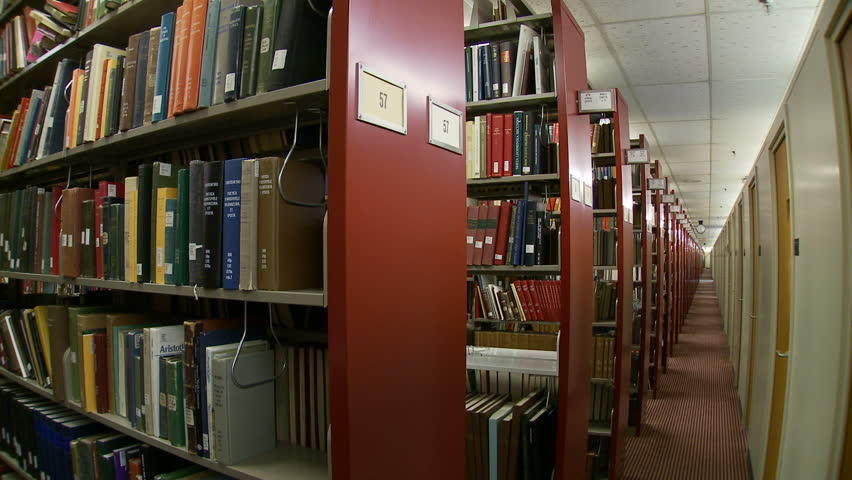 Woman Walks In And Out Stock Footage 100 Royalty Free Woman Walks In And Out Of The Library Stacks Down Shelves Back Sded Up Loopable Clip